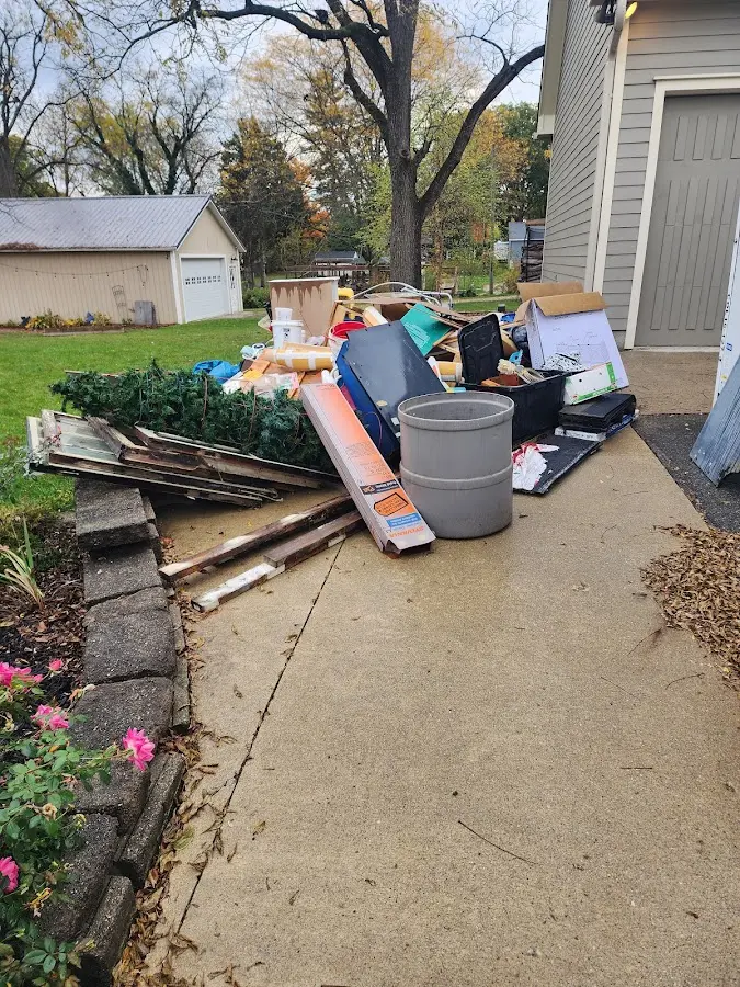Dumpster being loaded with debris for 12 Yard Dumpster Rental in Renton